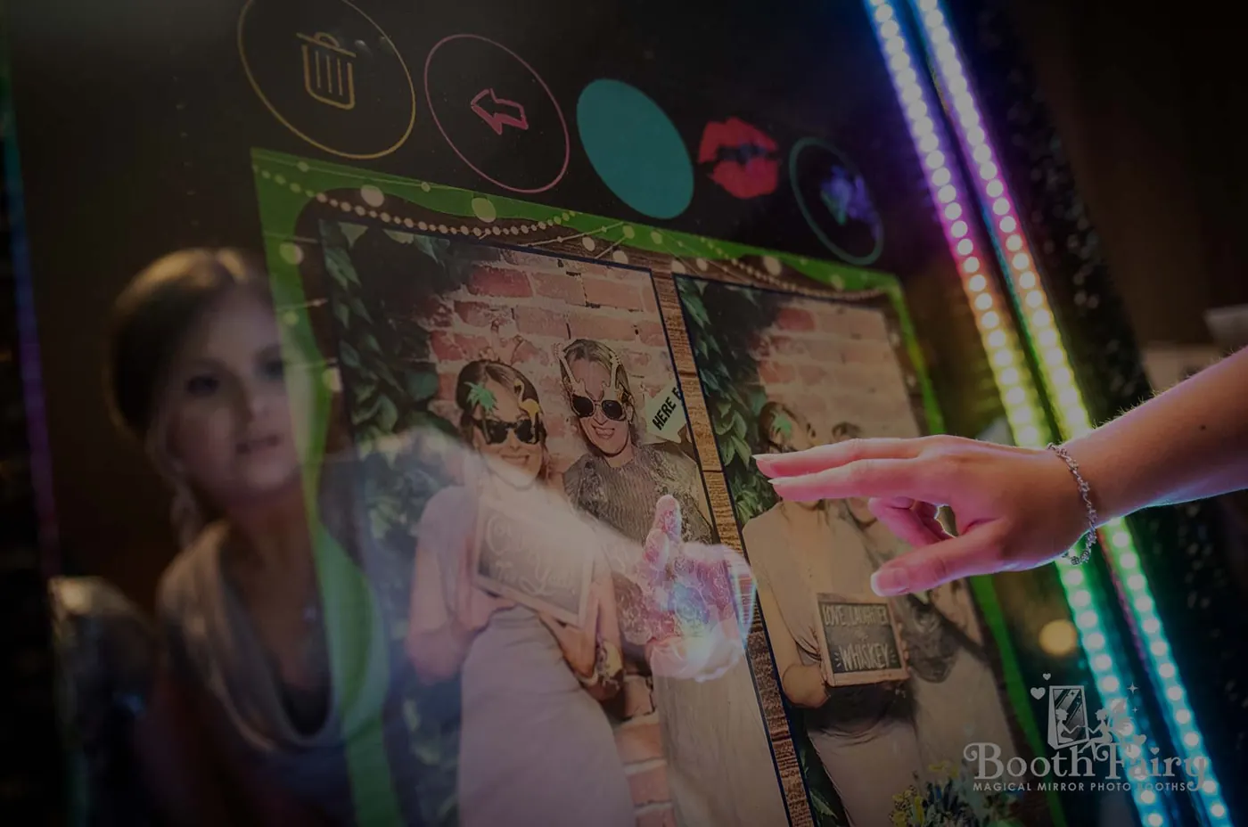 Guest touching a photo booth touchscreen to start a photo session